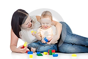 Child boy and mother playing together with construction set toy