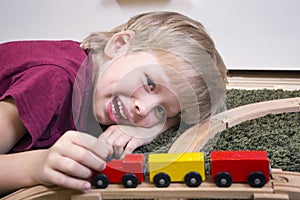 Child boy play with wooden train