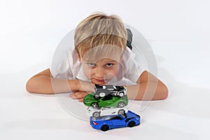 A child boy playing with car toys