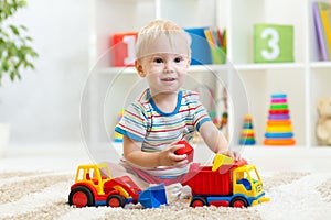 Child boy playing with toy car