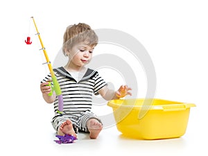 Child boy playing with toy rod