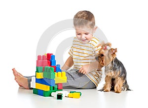 Child boy playing with toys and dog