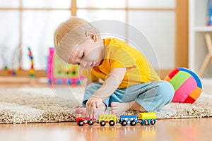 Child boy playing with toys indoor