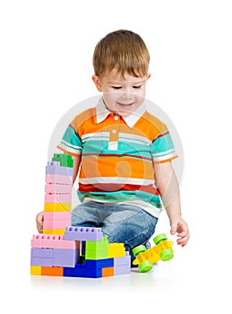 Child boy playing with toys over white background