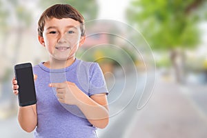 Child boy pointing at smartphone smart cell phone cellphone town copyspace copy space marketing ad advertising