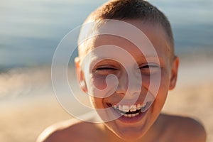 Child boy portrait close up sunset backlight happy laughing braces teeth