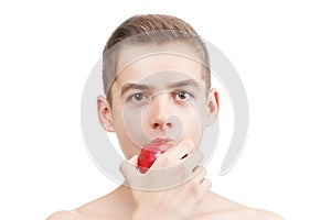 Child boy portrait eating ripe red apple isolated.