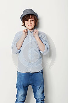 Child, boy and portrait for fashion in studio, cool clothing and confidence by white background. Happy male person, kid