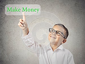 Child boy pressing make money button on touchscreen