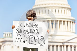 Protester boy holding sign I have special needs photo