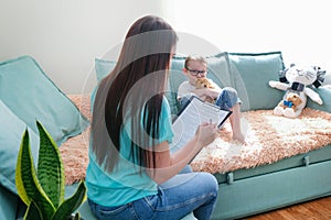 Child boy in the psychologists office. Psychologist talking to a child