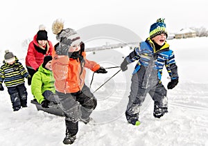 Child boy Pulling Sledge Through Snowy Landscape