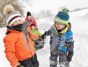 Child boy Pulling Sledge Through Snowy Landscape