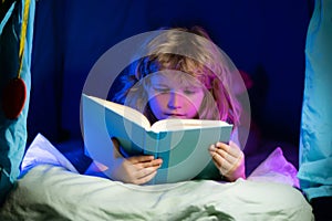 Child boy reading book. Close up portrait of kids reading story. Dreaming child read bedtime stories, fairystory or
