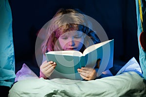 Child boy reading book. Close up portrait of kids reading story. Dreaming child read bedtime stories, fairystory or