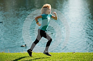 Child boy running outdoors. Child runner jogger running in the nature. Morning jogging. Active healthy kids lifestyle
