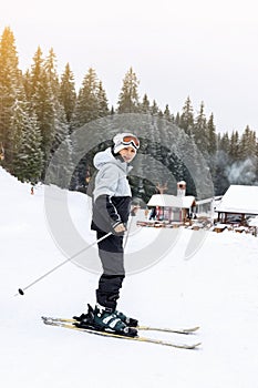 Child boy skier on ski slope of winter mountain resort Pamporovo, Bulgaria. Christmas holiday, family vacation outdoor