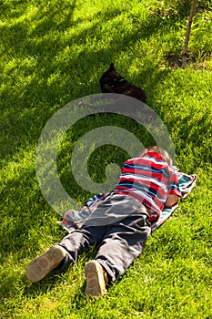 Child boy sleeping in grass