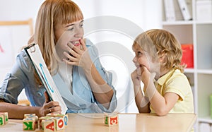 Child boy at speech therapist office photo