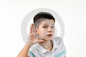 Child boy in striped t-shirt making hearing gesture