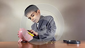 Child, boy in a suit fixing broken piggy bank. Recession, stagflation and negative returns conept