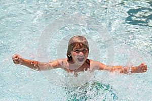 Child boy swim in summer swimming pool.
