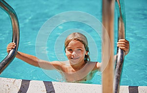 Child boy swim in swimming pool. Activities for happy children on the pool.