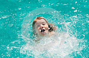 Child boy swim in swimming pool. Splash water. Little boy playing in outdoor swimming pool in water on summer vacation