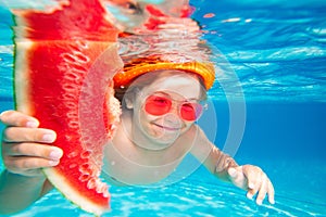 Child boy swim under water in sea. Kid swimming in pool underwater. Happy boy swims in sea underwater, active kid