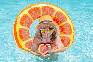 Child boy in swimming pool. Little kid boy having fun in the pool. Outdoor summer activity for children. Child in