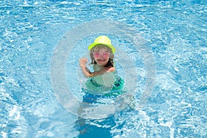 Child boy in swimming pool on summer vacation. Beach sea and water fun with children.