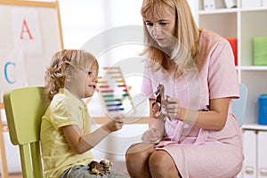 Child boy talking with psychologist