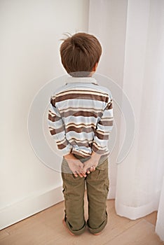 Child boy, trouble and time out for bad behaviour, discipline and parenting in family home. Punishment, small kid or son