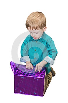 Child boy unwraps the gift