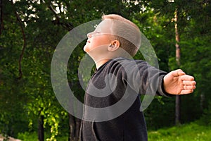 Child breathing in forest