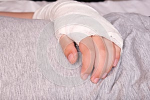 A child broken arm in plaster case, hand injury because of accident, forearm bones fracture