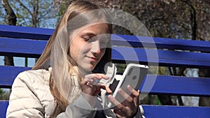 Child Browsing Internet on Smartphone in Park, Teenager Kid use Devices Outdoor on Bench, Adolescent Girl Playing Smart Phone