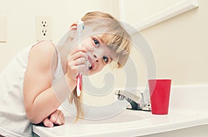 A child brushing teeth in bathroom