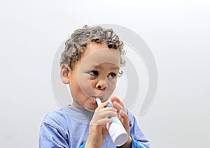 Child brushing teeth with an electric tooth brush