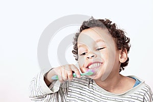 Child brushing teeth with an electric tooth brush stock photo