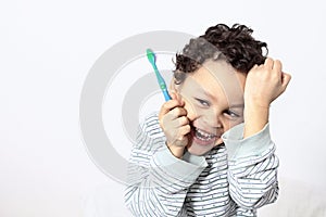 Child brushing teeth with an electric tooth brush stock photo