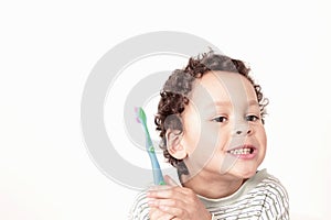 Child brushing teeth with an electric tooth brush stock photo