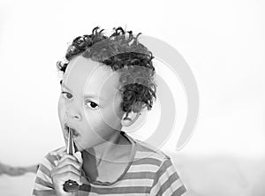 Child brushing teeth with an electric tooth brush stock photo