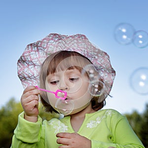 Child and bubble outdoors