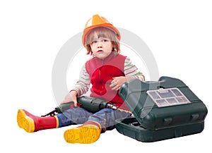 Child in builder hard hat with tools