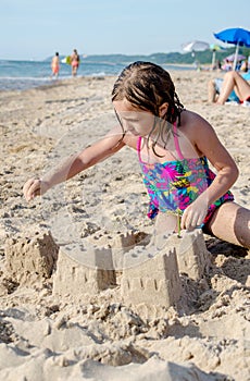 Child building castles on the beach