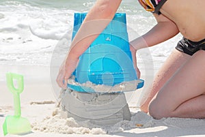 Child building sand castle