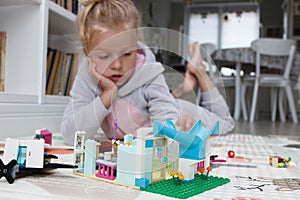 Child builds with constructor bricks, plays with toys