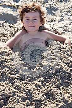 Child buried in the sand