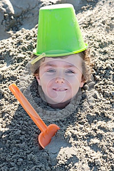 Child buried in the sand